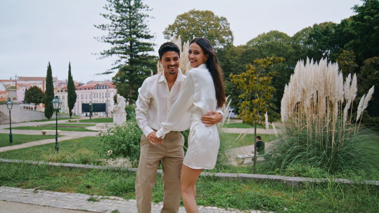 Romantic sweethearts spinning at park. Latina carefree couple embracing at date